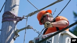A worker installs fiber optic cable to bring broadband internet service to a rural area near Belfair, Wash., Aug. 4, 2021. High-speed internet is a key area of President Biden's $1 trillion infrastructure package passed by the Senate Aug. 10, 2021.