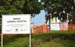 FILE - Health workers dressed in Ebola protective suits are seen readying an Ebola preparedness facility at the Bwera general hospital near the border with the Democratic Republic of Congo in Bwera, Uganda, June 12, 2019.