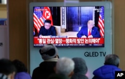 FILE - A TV shows a photo of U.S. President Donald Trump and North Korean leader Kim Jong Un, left, while people listen to Kim's New Year's speech, at Seoul Railway Station in Seoul, South Korea, Jan. 1, 2019.