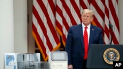 President Donald Trump listens during a briefing about the coronavirus in the Rose Garden of the White House, May 11, 2020.