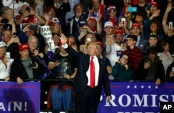U.S. President Donald Trump waves after a campaign rally in Washington Township, Michigan, April 28, 2018.
