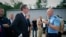 In this photograph made available by the Serbian Presidency, a Kosovo police officer speaks to Serbia's president Aleksandar Vucic, left, to say he cannot continue his trip to the village of Banje due to roadblocks, in Zubin Potok, Sept. 9, 2018.