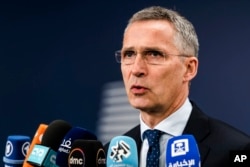 FILE - NATO Secretary-General Jens Stoltenberg talks with journalists as he arrives for a meeting of EU foreign and defense ministers at the Europa building in Brussels, May 18, 2017.