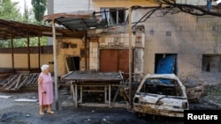 A woman walks at a site of a recent shelling, which local Russian-installed authorities called a Ukrainian military strike, in the course of Russia-Ukraine conflict in Donetsk, Russian-controlled Ukraine, July 22, 2024. 