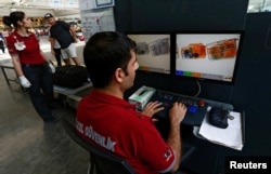 Security officers work on an X-ray machine at Turkey's largest airport, Istanbul Ataturk, following Tuesday's deadly blast, June 29, 2016.