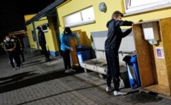 Players go through a disinfection routine prior to the last training session of a youth soccer team of sports club " BLAU-GELB" before lockdown as the spread of the coronavirus disease (COVID-19) continues in Frankfurt, Germany, Oct. 30, 2020.