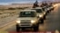 FILE - An image made available by propaganda Islamist media outlet Welayat Tarablos on Feb. 18, 2015, allegedly shows members of the Islamic State (IS) militant group parading in a street in Libya's coastal city of Sirte, which lies 500 kilometers (310 miles) east of the capital, Tripoli. 