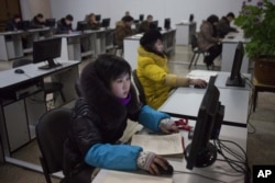 FILE - North Koreans work at computer terminals inside the Grand People's Study House in Pyongyang, North Korea, January 9, 2013.