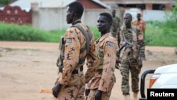 South Sudanese policemen and soldiers stand guard along a street following renewed fighting in South Sudan's capital Juba, July 10, 2016. 