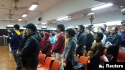 FILE - About 200 Catholics attend a prayer meeting for the Chinese Church after news emerge that Beijing and the Vatican have reached a deal on bishop appointments, in Hong Kong, China, Feb. 12, 2018. 