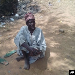 Petty trader Roni Abdullahi Badamasi rests beneath a shady tree, where the radical Islamic sect Boko Haram is accused of escalating attacks against the government, in the northern city of Kano, Nigeria, February 16, 2012.