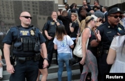 FILE - Family members of detainees line up to enter the federal court just before a hearing to consider a class-action lawsuit filed on behalf of Iraqi nationals facing deportation, in Detroit, Michigan, June 21, 2017.