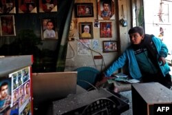 Syrians check the site of a suicide attack targeting U.S.-led coalition forces the day before in Manbij, Syria, Jan. 17, 2019.