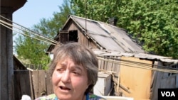 Lena holding up one of her pigeons (Jamie Dettmer/VOA)