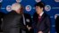 Japanese Prime Minister Shinzo Abe is greeted by U.S. Chamber of Commerce President and CEO Tom Donohue, left, as he arrives at a meeting at chamber offices in Washington, April 29, 2015.