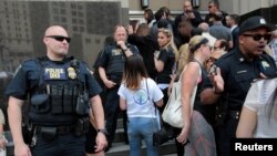 Family members of detainees line up to enter the federal court just before a hearing to consider a class-action lawsuit filed on behalf of Iraqi nationals facing deportation, in Detroit, Michigan, June 21, 2017.