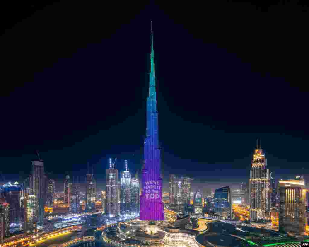 A handout image made available by the Mohammed Bin Rashid Al Maktoum Global Initiatives (MBRGI) shows Burj Khalifa during a light show to mark "10 million meals" Covid-19 campaign in Dubai, UAE.