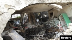 Burnt newspaper copies are seen in the rubble of a destroyed ThisDay newspaper building in Abuja April 28, 2012.