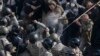 Radical protesters, including supporters of the All-Ukrainian Union Svoboda (Freedom) Party, clash with law enforcement members during a rally near the parliament building in Kyiv, October 14, 2014.