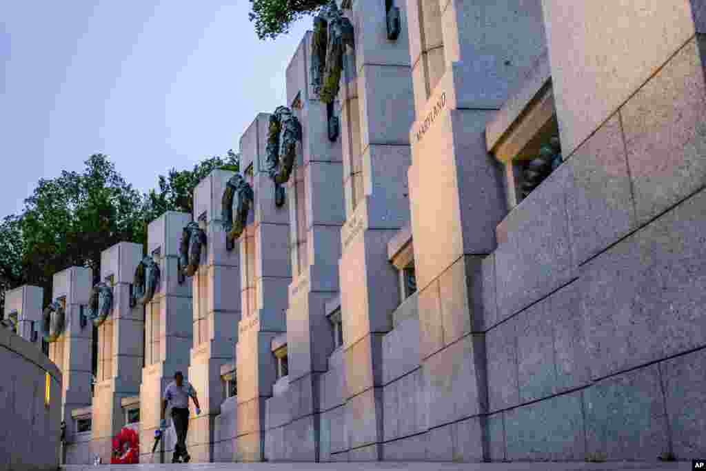 A member of the National Park Service inspects the walkway at the World War II Memorial early in the morning before the Memorial Day events in Washington, May 29, 2017.