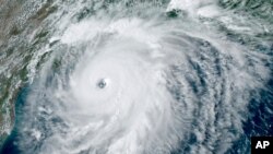 This GOES-16 GeoColor satellite image taken August 26, 2020, at 4:50 p.m. EDT, and provided by NOAA, shows Hurricane Laura over the Gulf of Mexico. 