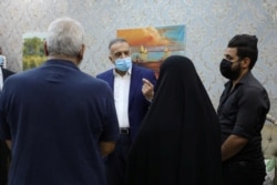 FILE - Iraqi Prime Minister Mustafa al-Kadhimi offers condolences to the family of Reham Yacoub, a female activist who was killed by unidentified gunmen, in Basra, Iraq, Aug. 22, 2020.