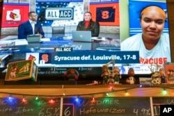 A TV at The Sports Bra sports bar in Portland, Ore., displays Syracuse's Emma Ward on ACC Network's "All ACC" after an NCAA college lacrosse game on Wednesday, April 24, 2024. (AP Photo/Jenny Kane)