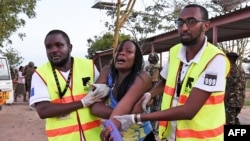 Paramedics help a student who was injured during an attack by Somalia's al-Qaida-linked al-Shabab gunmen at Garissa University College, Kenya, April 2, 2015. 