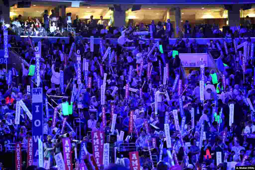 Convention attendees hold signs reading "America" during the second night of the Democratic National Convention in Philadelphia, July 26, 2016 (A. Shaker/VOA)