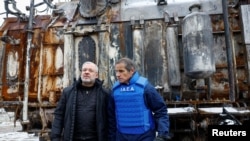 Ukrainian Energy Minister German Galushchenko, left, and International Atomic Energy Agency Director General Rafael Grossi, right, visit an energy infrastructure facility damaged during Russian missile and drone strikes in an undisclosed location in Ukraine, Feb. 4, 2025.