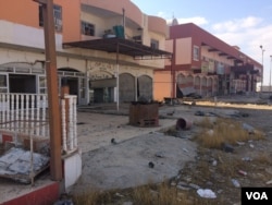 A few residents return to Bartella, Iraq, to find their homes destroyed and their city in shambles, Nov. 2, 2016. (H. Murdock/VOA)