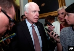 Sen. John McCain, R-Ariz., speaks with reporters before heading into a policy luncheon on Capitol Hill, Sept. 19, 2017, in Washington.