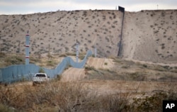 FILE - A U.S. Border Patrol agent drives near the U.S.-Mexico border fence in Sunland Park, N.M. The building of a border wall was one of the main tenets of the Donald Trump campaign.
