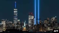 FILE - The Statue of Liberty shines on Sept. 11, 2021 near the Tribute in Light as part of the commemoration for 20th anniversary of the terrorist attack in New York City. 