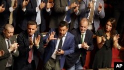 Italian Interior Minister and Deputy-Premier Matteo Salvini is applauded by The League party's lawmakers as he addresses the Senate in Rome, Aug. 13, 2019.