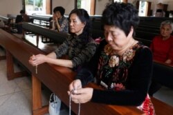 Catholics who traveled from Shanghai to Bangkok to attend mass held by Pope Francis, pray at the Holy Redeemer Church in Bangkok, Thailand, Nov. 19, 2019.