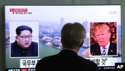 A man watches a TV screen showing file footage of U.S. President Donald Trump, right, and North Korean leader Kim Jong Un during a news program at the Seoul Railway Station in Seoul, South Korea, May 16, 2018. 