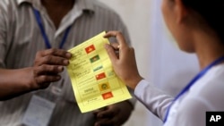 Officials of Union Election Commission count ballots at a polling station in Yangon, Myanmar, April 1, 2017. 