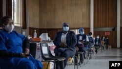 Health care workers await doses to start vaccinating people with Pfizer vaccines at the Bertha Gxowa Hospital in Germiston, South Africa, May 17, 2021. 