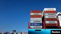 FILE - Containers are stacked on a ship in the port of Lazaro Cardenas, Mexico, Nov. 21, 2013. 
