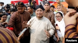 FILE - Prabowo Subianto, challenger to incumbent President Joko Widodo, leaves a ceremony marking the start of the campaigning period for next year's election in Jakarta, Indonesia, Sept. 23, 2018. 