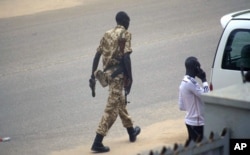 FILE - A South Sudan soldier patrols the street in Juba, South Sudan, July 11, 2016.