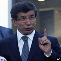 Turkish Foreign Minister Ahmet Davutoglu addresses the media in Ankara, August 10, 2011