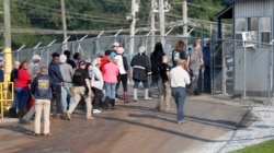 Workers exit a Koch Foods Inc. processing plant as U.S. immigration officials conducted a raid in Morton, Miss., Aug. 7, 2019.