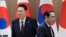 FILE - South Korea's President Yoon Suk Yeol, left, and Japan's Prime Minister Fumio Kishida move their positions during a meeting at the Presidential Office in Seoul on May 26, 2024.