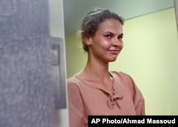 FILE - Anastasia Vashukevich leaves the Pattaya Provincial Court in Chonburi province, Thailand, Aug. 20, 2018.