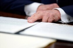 President Donald Trump speaks before signing an executive order aimed at curbing protections for social media giants, in the Oval Office of the White House, May 28, 2020.