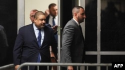 Manhattan District Attorney Alvin Bragg, left, returns to the courtroom following a break during a hearing about Donald Trump's hush money trial at Manhattan Criminal Court in New York on March 25, 2024. Bragg sought, and was granted, a gag order against Trump.