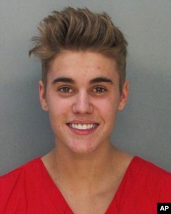 This police booking mug made available by the Miami Dade County Corrections Department shows pop star Justin Bieber, Jan. 23, 2014.
