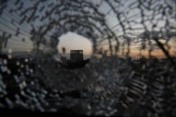 FILE - A building is seen through a bullet hole in a window of the Africa Hotel in the town of Shire, Tigray region, Ethiopia, March 16, 2021.